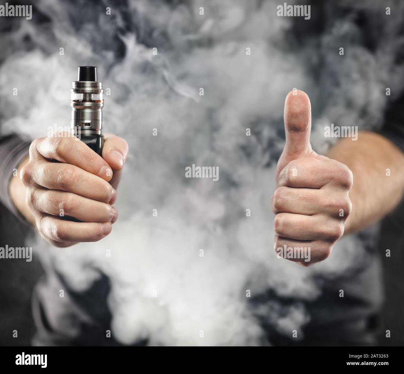 Vaping flavored e-liquid from an electronic cigarette Stock Photo