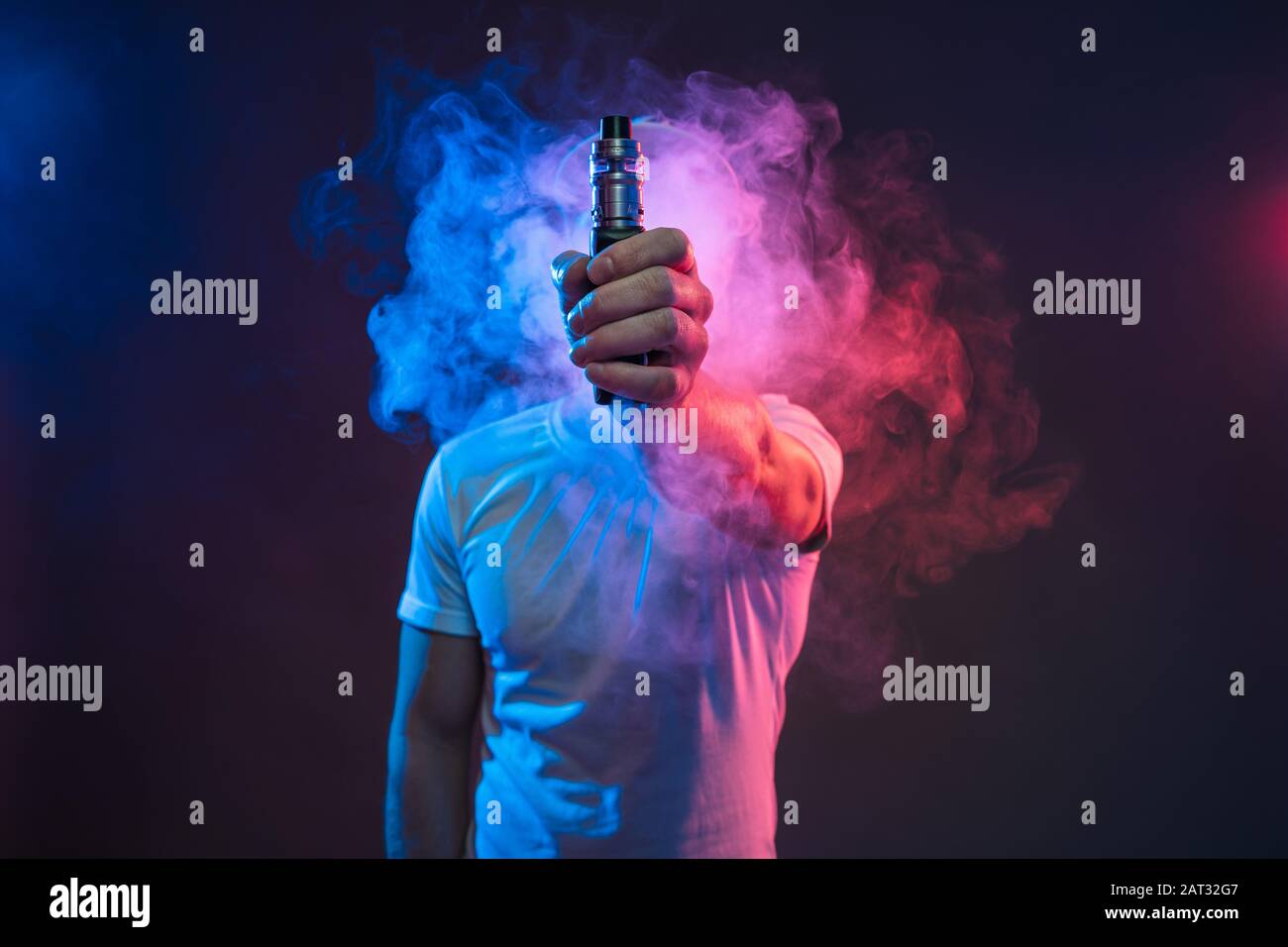 Vaping flavored e-liquid from an electronic cigarette Stock Photo