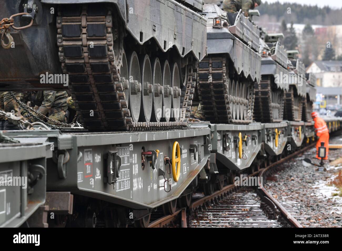 30 January 2020, Saxony, Marienberg: Infantry fighting vehicles 'Marder' of the Panzergrenadierbataillon 371 from Marienberg in Saxony are loaded onto railway goods trailers. With the transport, tanks 'Marder', recovery tanks 'Büffel' and wheeled vehicles go to Rukla in Lithuania. The Panzergrenadierbataillon 371 replaces there the Bataillon 391 from Bad Salzungen after its six-month engagement. The 'Marienberger Jäger' are participating in the contract for the second time. The main task is to show presence and practice together with multinational partners and the Lithuanian armed forces. Sinc Stock Photo
