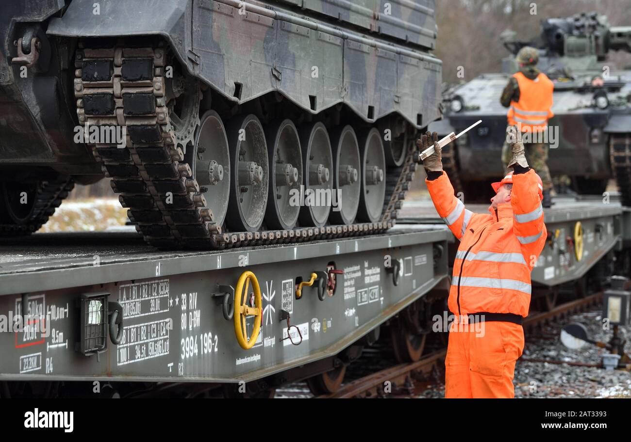 30 January 2020, Saxony, Marienberg: Infantry fighting vehicles 'Marder' of the Panzergrenadierbataillon 371 from Marienberg in Saxony are loaded onto railway goods trailers. With the transport, tanks 'Marder', recovery tanks 'Büffel' and wheeled vehicles go to Rukla in Lithuania. The Panzergrenadierbataillon 371 replaces there the Bataillon 391 from Bad Salzungen after its six-month engagement. The 'Marienberger Jäger' are participating in the contract for the second time. The main task is to show presence and practice together with multinational partners and the Lithuanian armed forces. Sinc Stock Photo