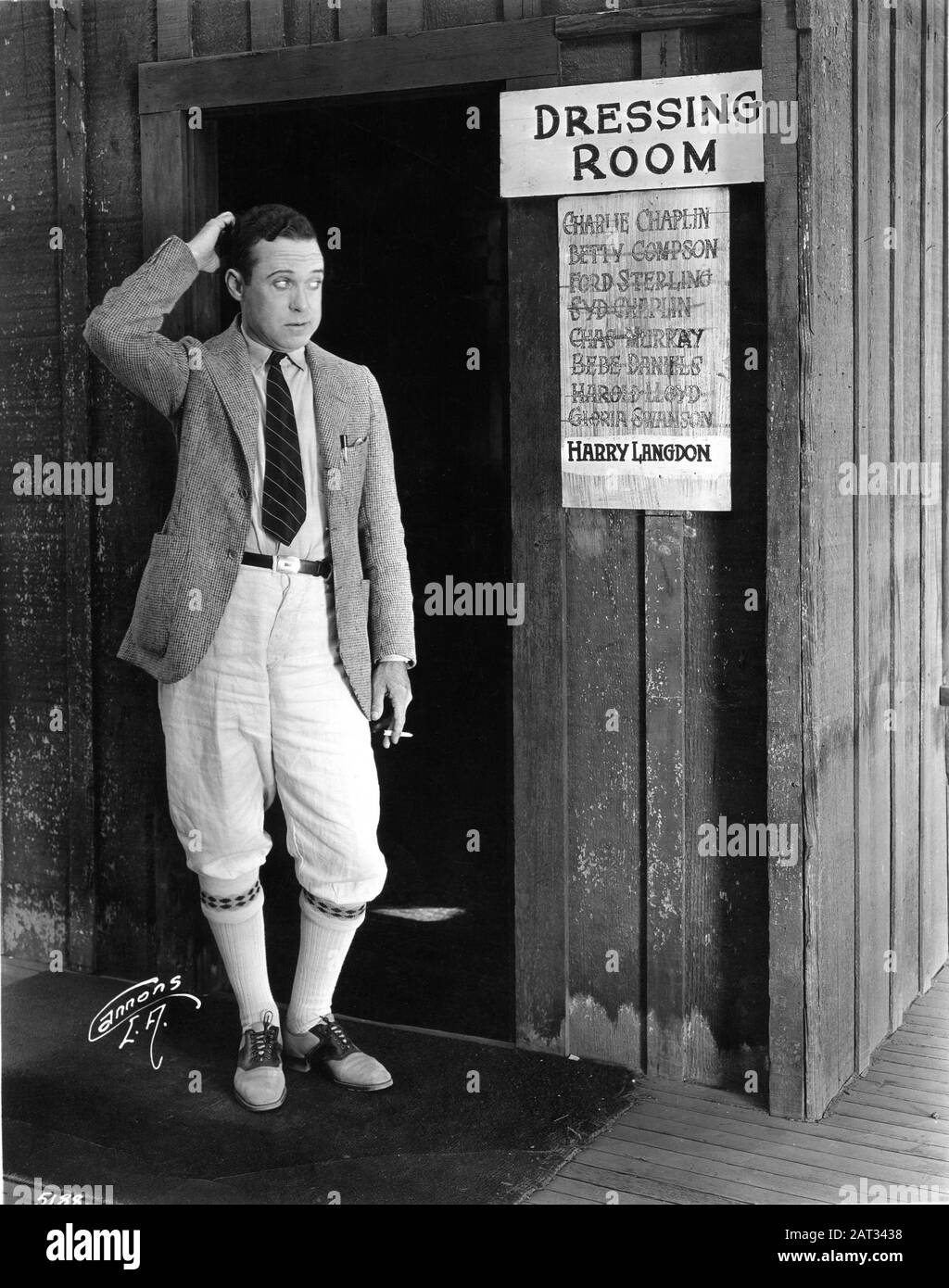 Silent Movie Comedian HARRY LANGDON Publicity Pose outside his dressing room at MACK SENNETT STUDIOS in 1924 Photo by GEORGE F. CANNONS Stock Photo