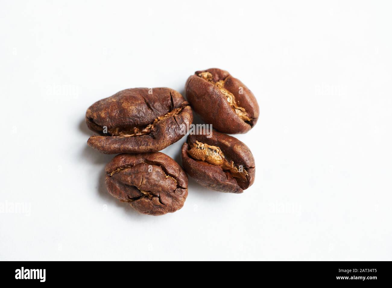 Bad coffee beans on a white background. Close up Stock Photo Alamy
