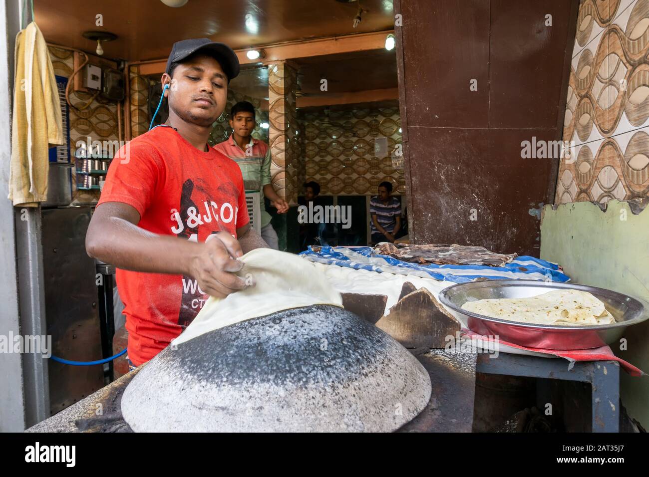 Chandani Roti Old Delhi, India - March 4, 2018: Unidentified Man baking an chapati ...