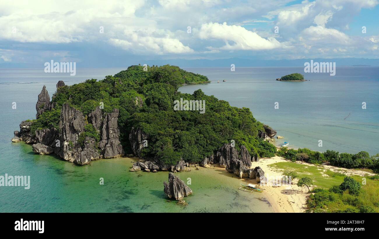 Tropical island with a white beach and limestone cliffs, aerial view. Sabitang Laya, Caramoan island, Philippines, Asia. Summer and travel vacation concept. Stock Photo