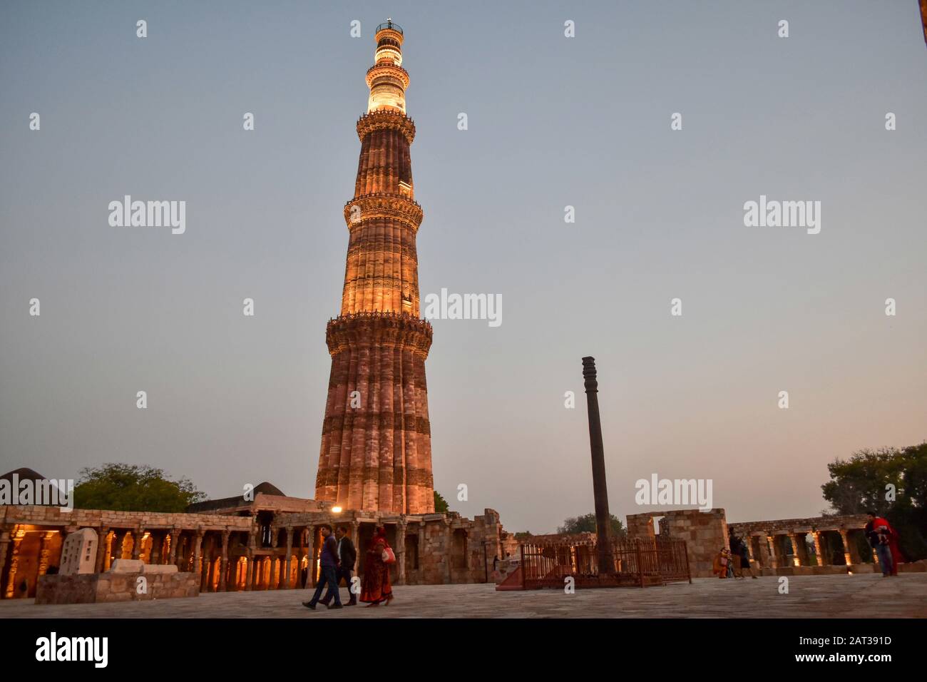 Visitors walk around the historic Qutub Minar in Delhi.Qutub Minar, a UNESCO World Heritage Site, is the tallest minaret in India. The Qutub Minar was built in the early 13th century a few kilometers south of Delhi. Stock Photo