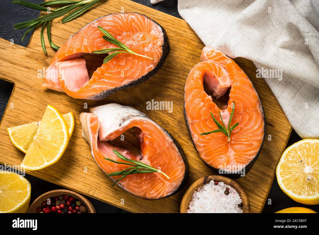 Raw salmon steak on black top view Stock Photo Alamy