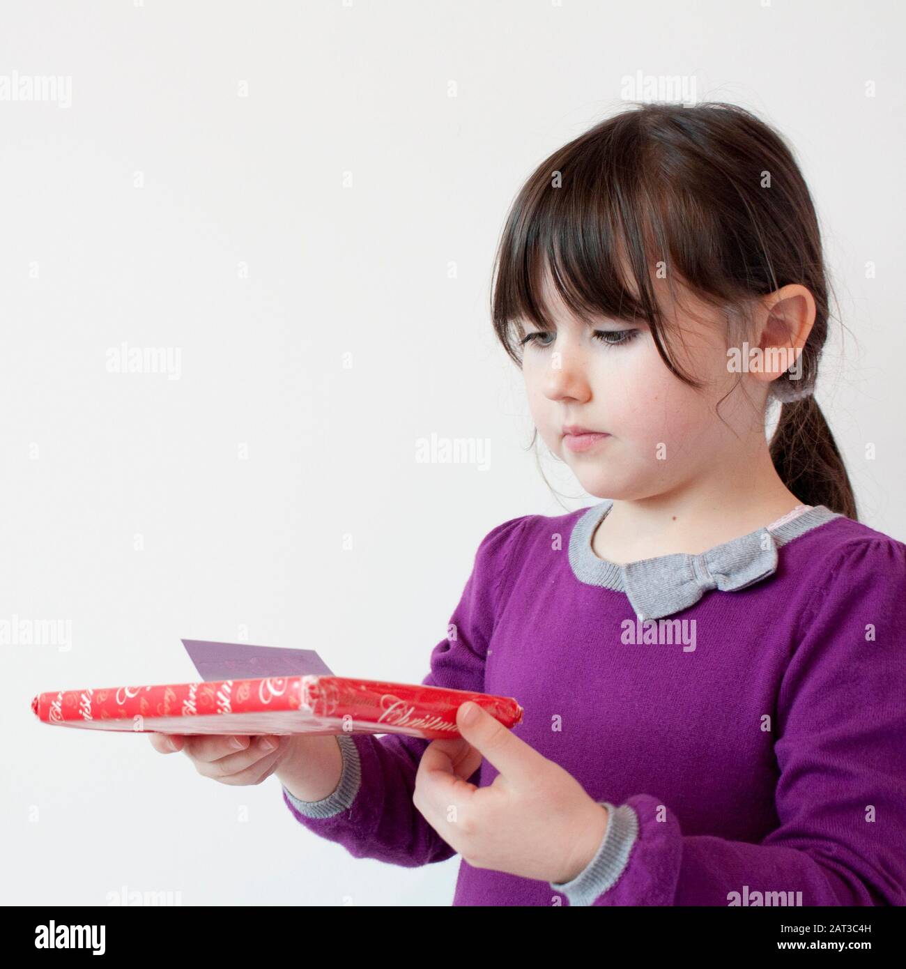 Young girl receiving a gift at Christmas Stock Photo Alamy