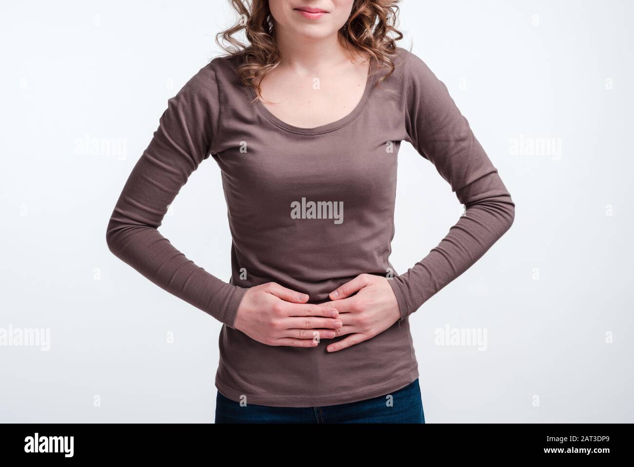 Young girl with abdominal pain close up, stomach pain clutching her