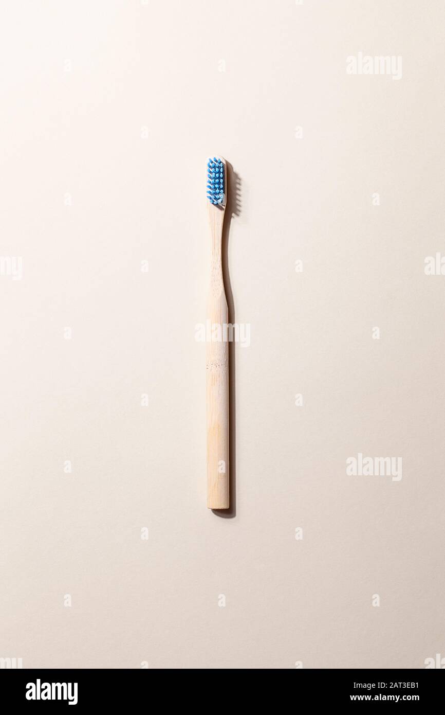 Bamboo toothbrushes on light background with shadow and copy space ...