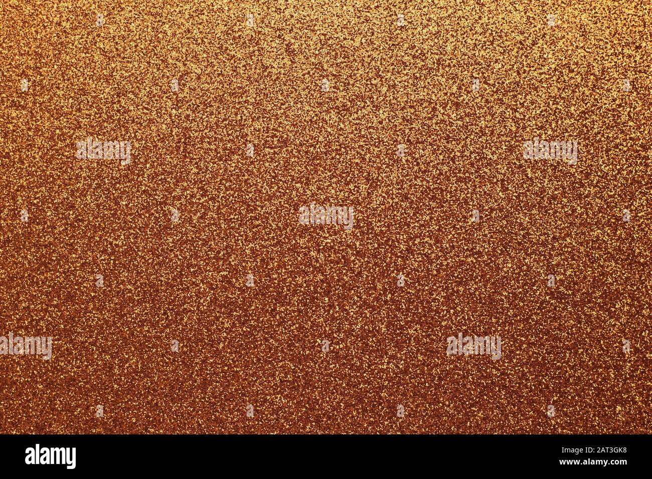 Golden shiny background, yellow sparkles, brown grainy texture. Material pattern, metallic tinsel, decoration Stock Photo