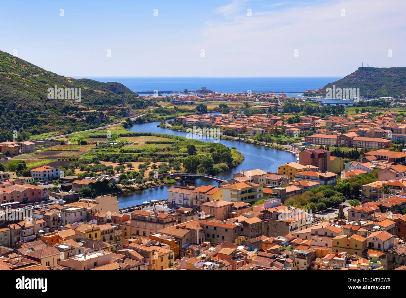 Bosa, Sardinia / Italy - 2018/08/13: Panoramic view of the town of Bosa by the Temo river with Bosa Marina resort at the Mediterranean sea coast seen from Malaspina Castle hill - known also as Castle of Serravalle Stock Photo