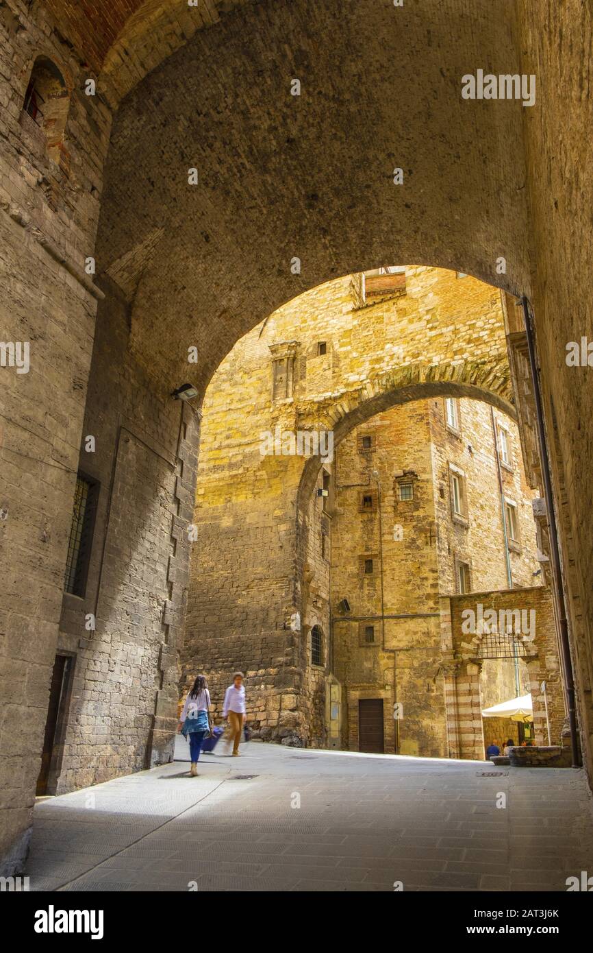 Perugia, Umbria / Italy - 2018/05/28: Medieval arch forming a gate to the old town quarter from the aqueduct valley and Via dell Aquedotto and Via Appia historic roman empire streets Stock Photo