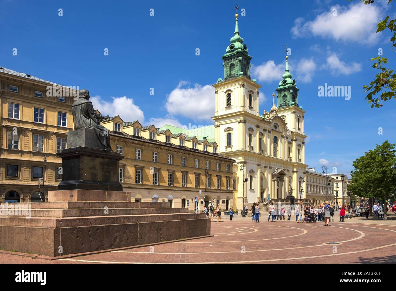 Warsaw, Mazovia / Poland - 2019/06/01: Front view of the baroque Holy Cross Church and the Mikolaj Kopernik statue, at the Krakowskie Przedmiescie street in the Old Town quarter of Warsaw Stock Photo