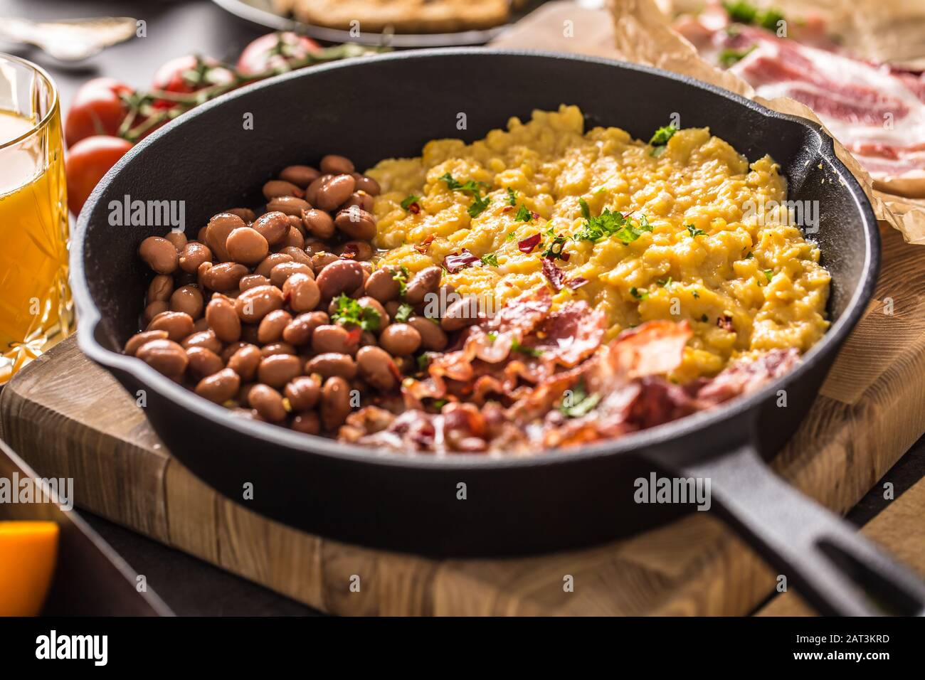 Full table of english breakfast. Scrambled eggs grilled bacon beans