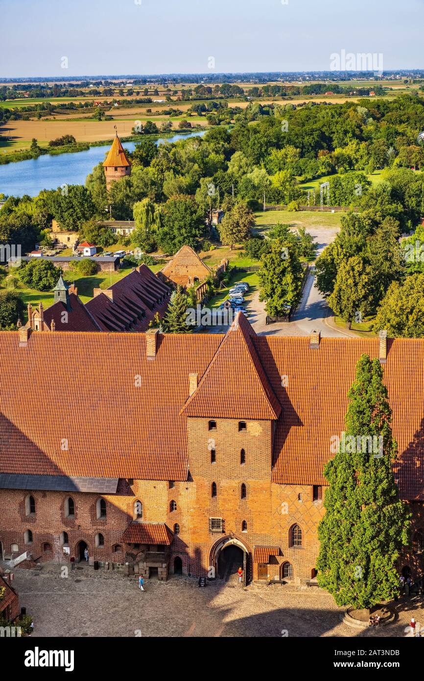 Malbork, Pomerania / Poland - 2019/08/24: Aerial panoramic view of the inner courtyard with the gate tower in the Middle Castle part of the medieval Teutonic Order Castle by the Nogat river in Malbork, Poland Stock Photo