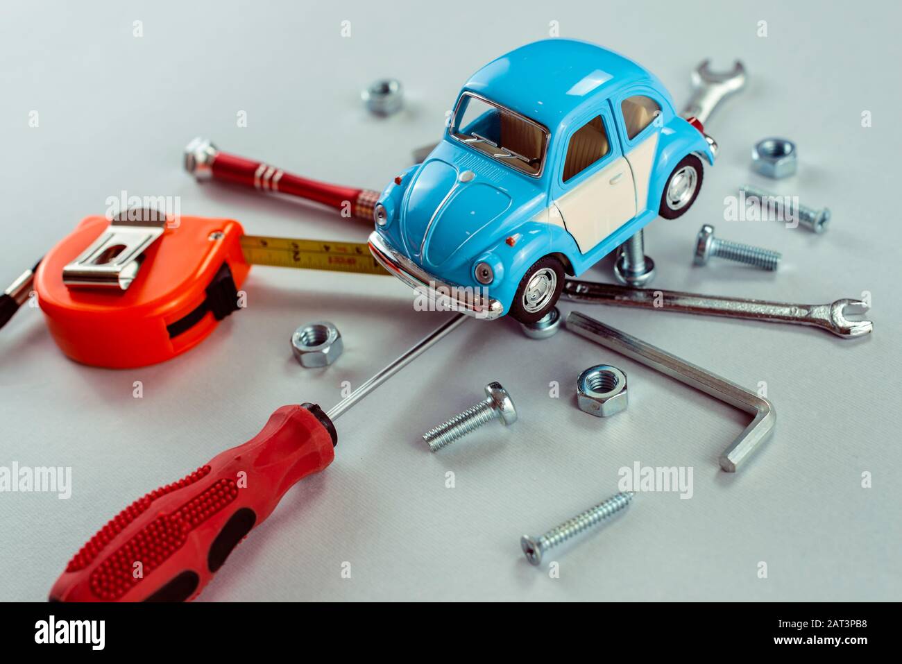 Closeup set of tools wrenches with blue toy car. Car repair