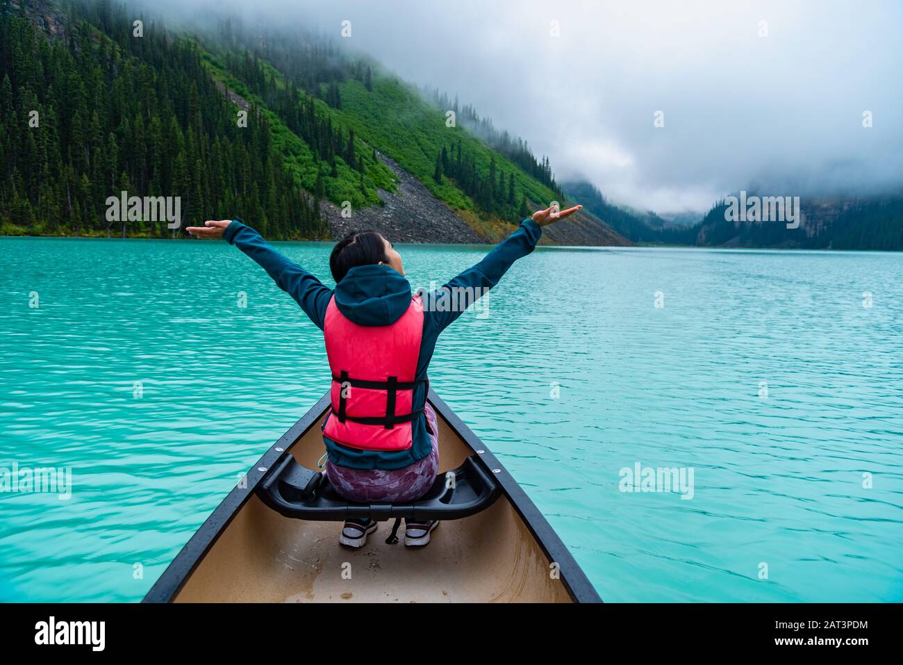 Woman enjoying the view of Lake Louise from Canoe Stock Photo - Alamy