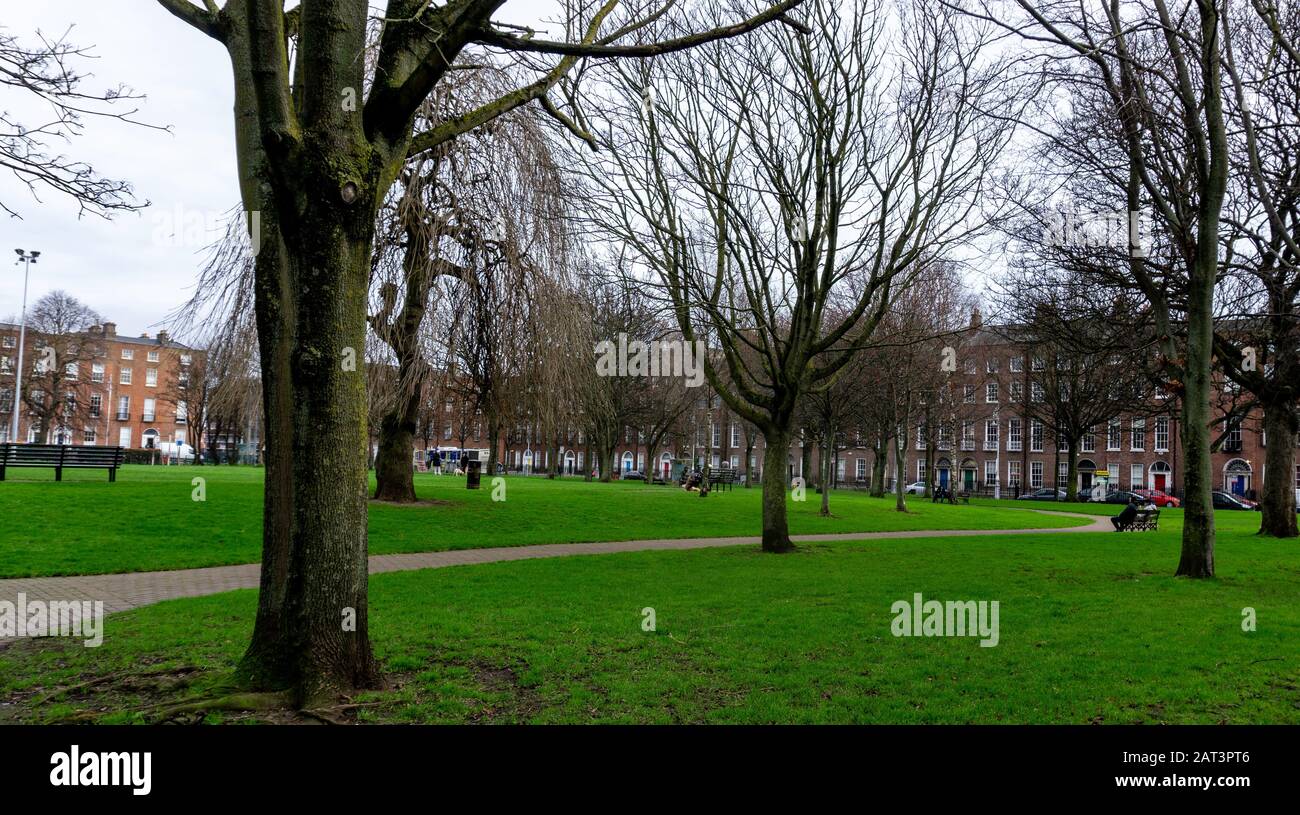 Mountjoy Square public park, with the buildings of Mountjoy Square in the background. This Georgian Square was  developed in the 18th century. Stock Photo