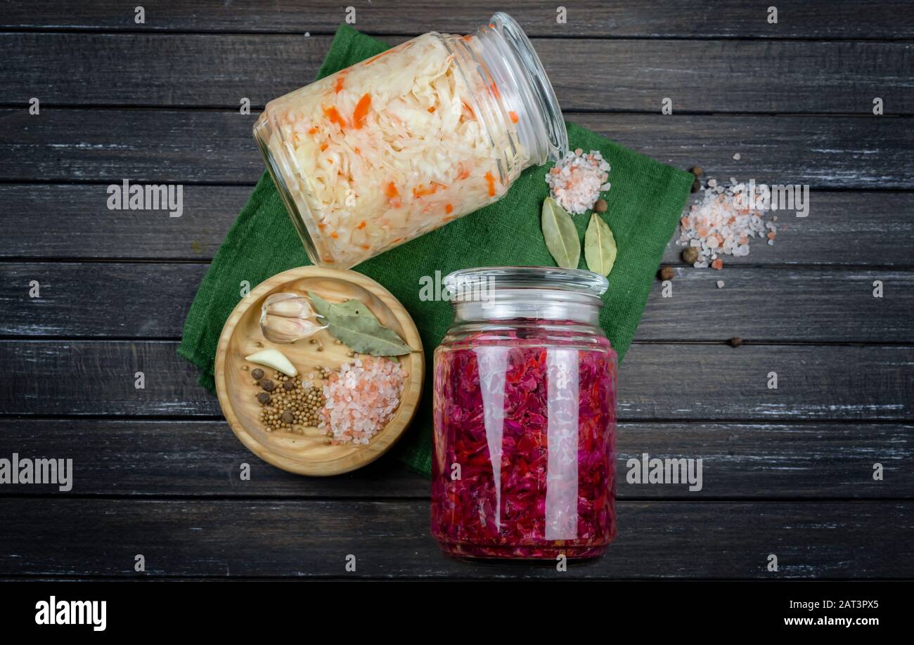 glass jars of fermented white, red cabbage, spices, salt. vegetables on
