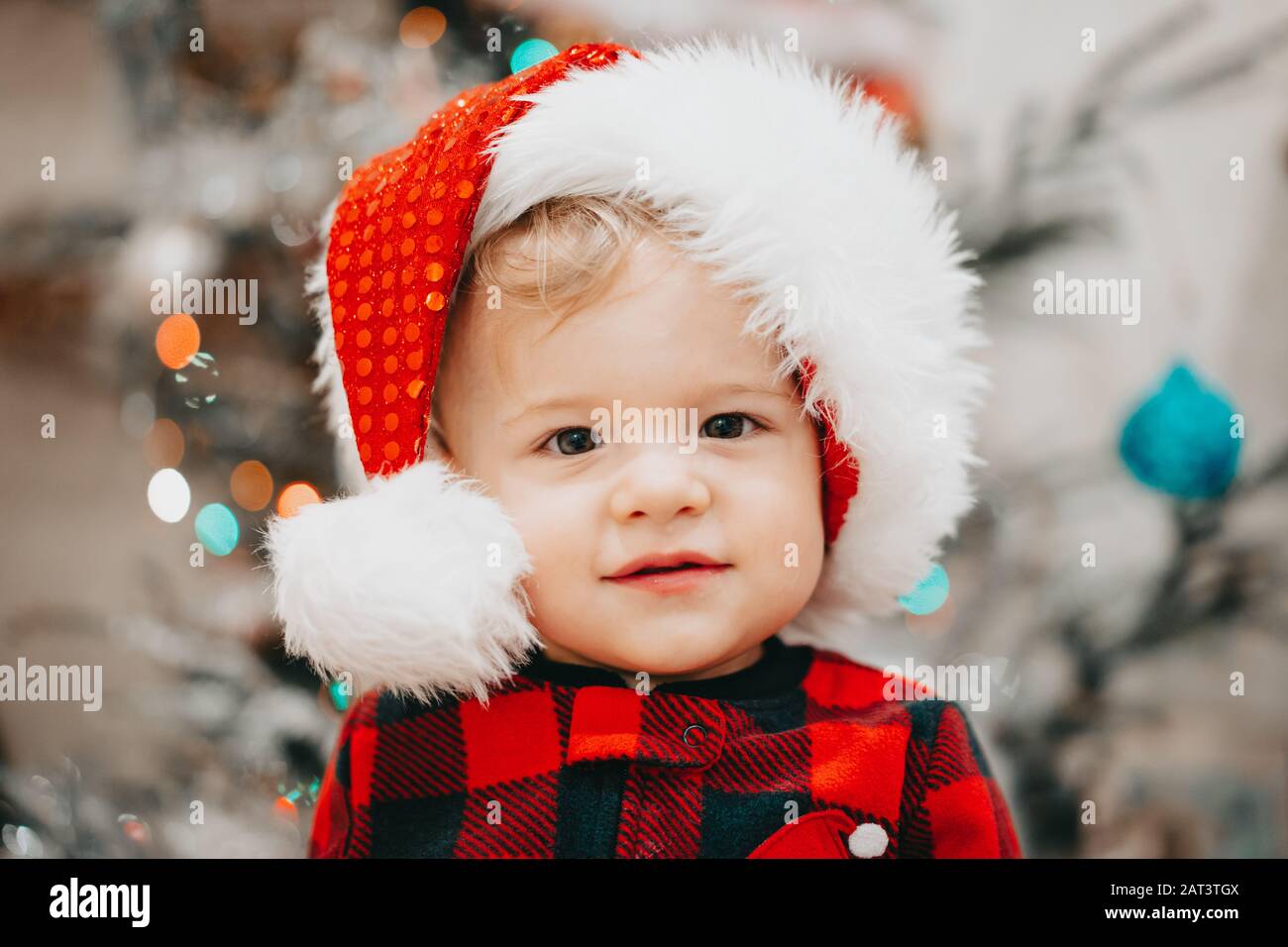 Very cute portrait of little baby boy in Santa hat on Christmas ...