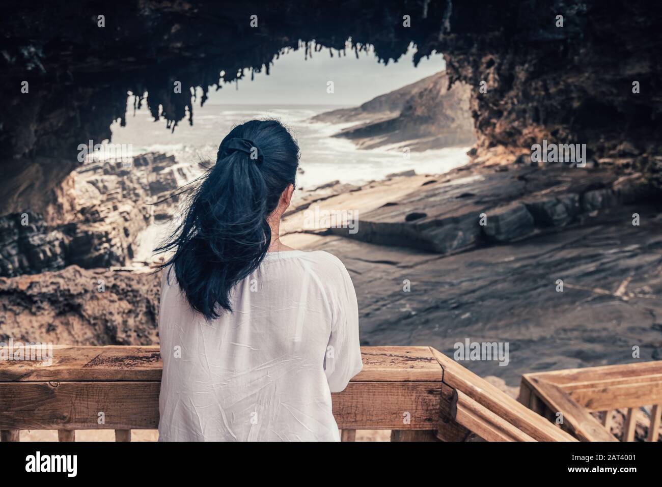 Woman enjoying the view through Admirals Arch, Kangaroo Island, South Australia Stock Photo