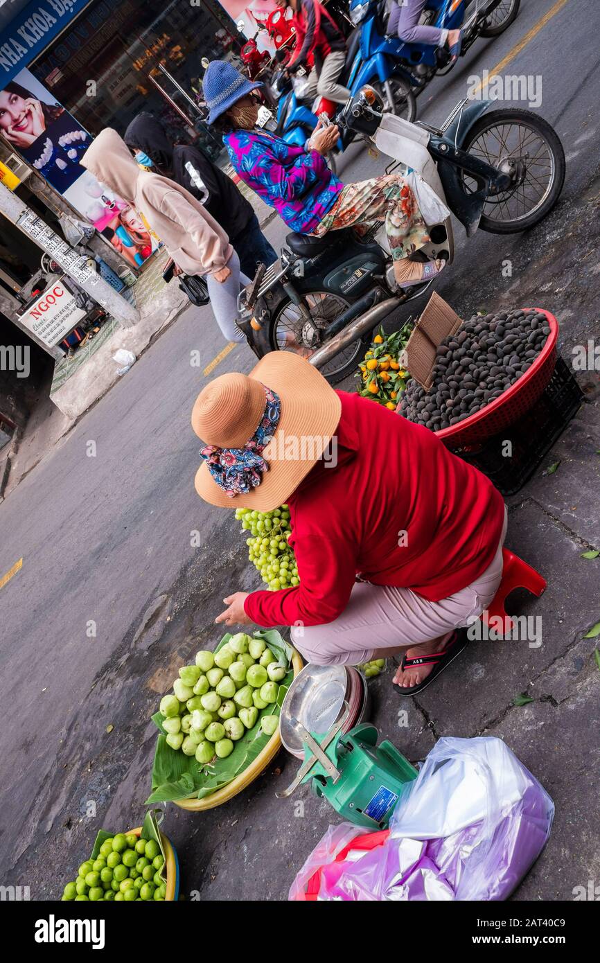 Woman selling fruit on the street near Tan Dinh market, Ho Chi Minh City, Vietnam Stock Photo