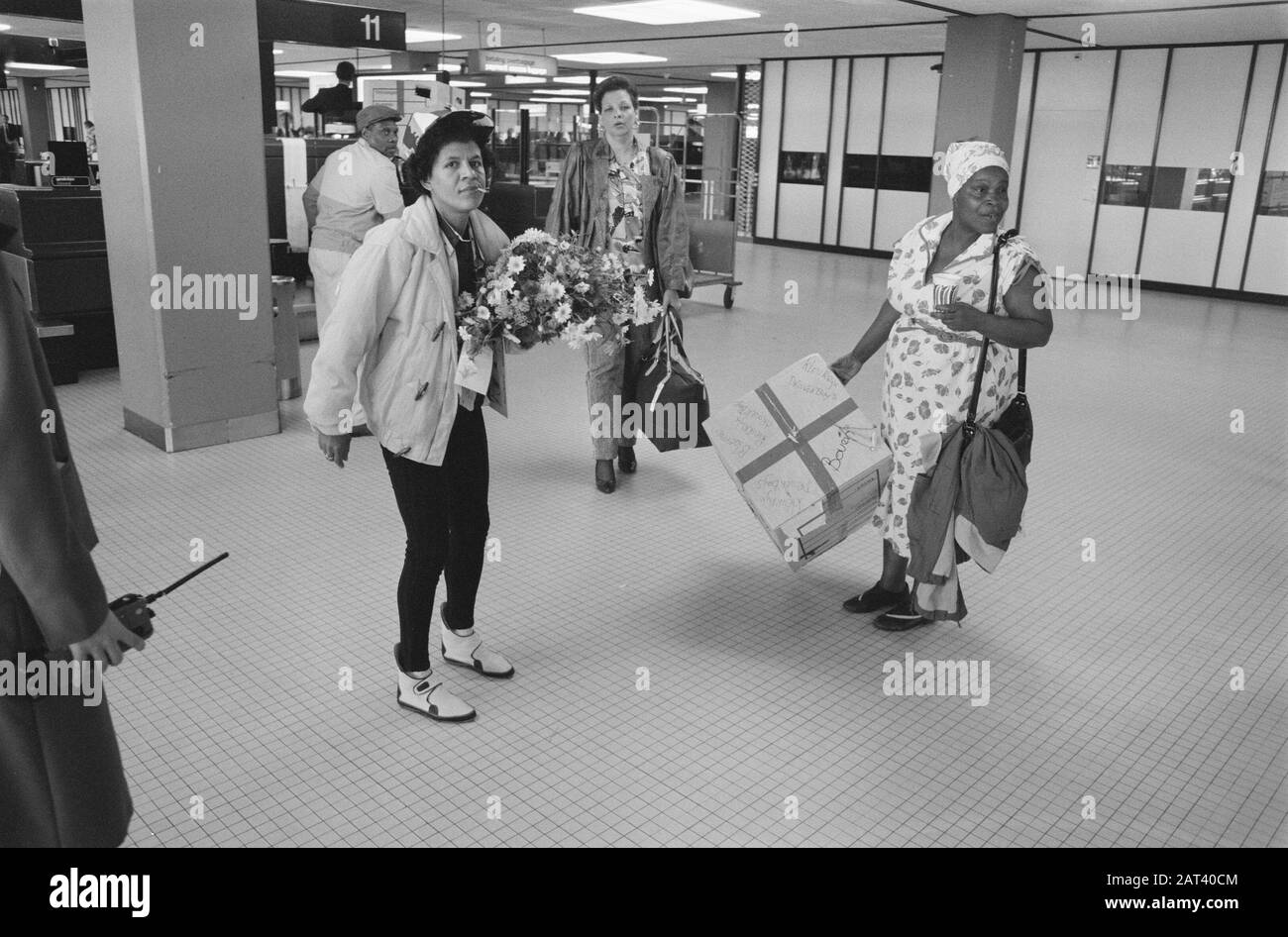 Departure to Suriname of the survivors of the victims of the plane crash  In the Departure Hall Date: 9 June 1989 Location: Noord-Holland, Schiphol Keywords: Airlines survivors, victims, departures, aircramps Stock Photo
