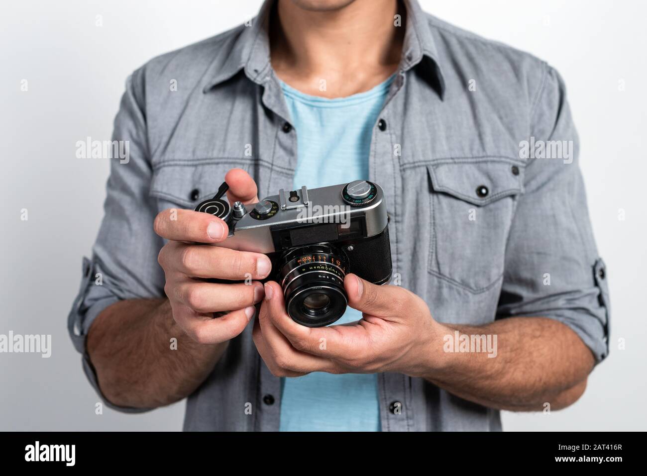 Closeup a retro photocamera in the male hands. Touristic concept image Stock Photo