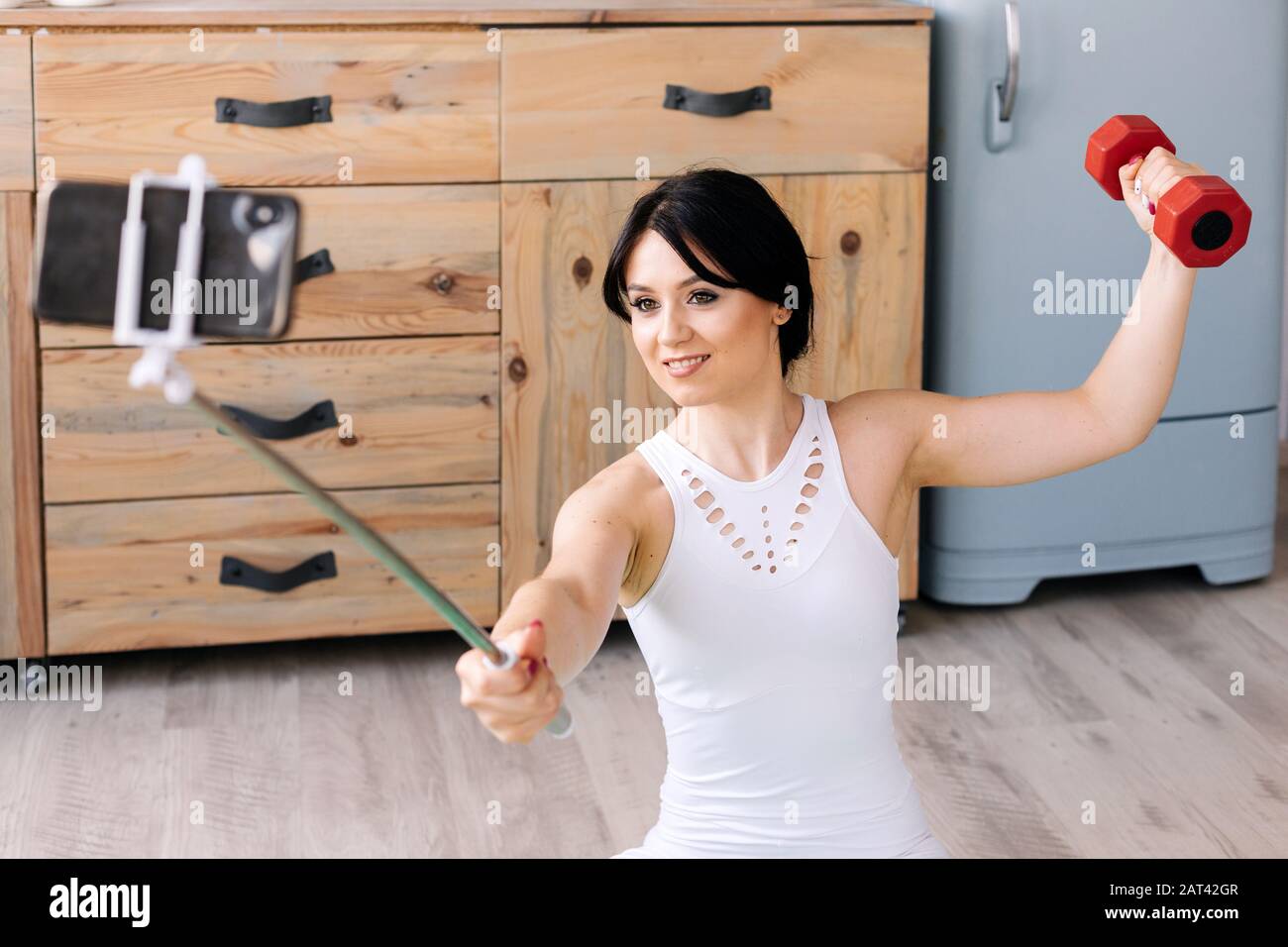 A positive woman taking selfie on cellphone during workout Stock Photo