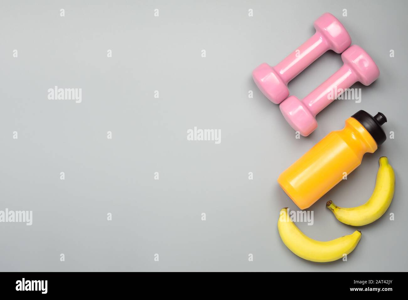Fitness, bodybuilding, active healthy lifestyle background concept. Sports  equipment on grey background, banana, bottle of water, dumbbell, top view w  Stock Photo - Alamy