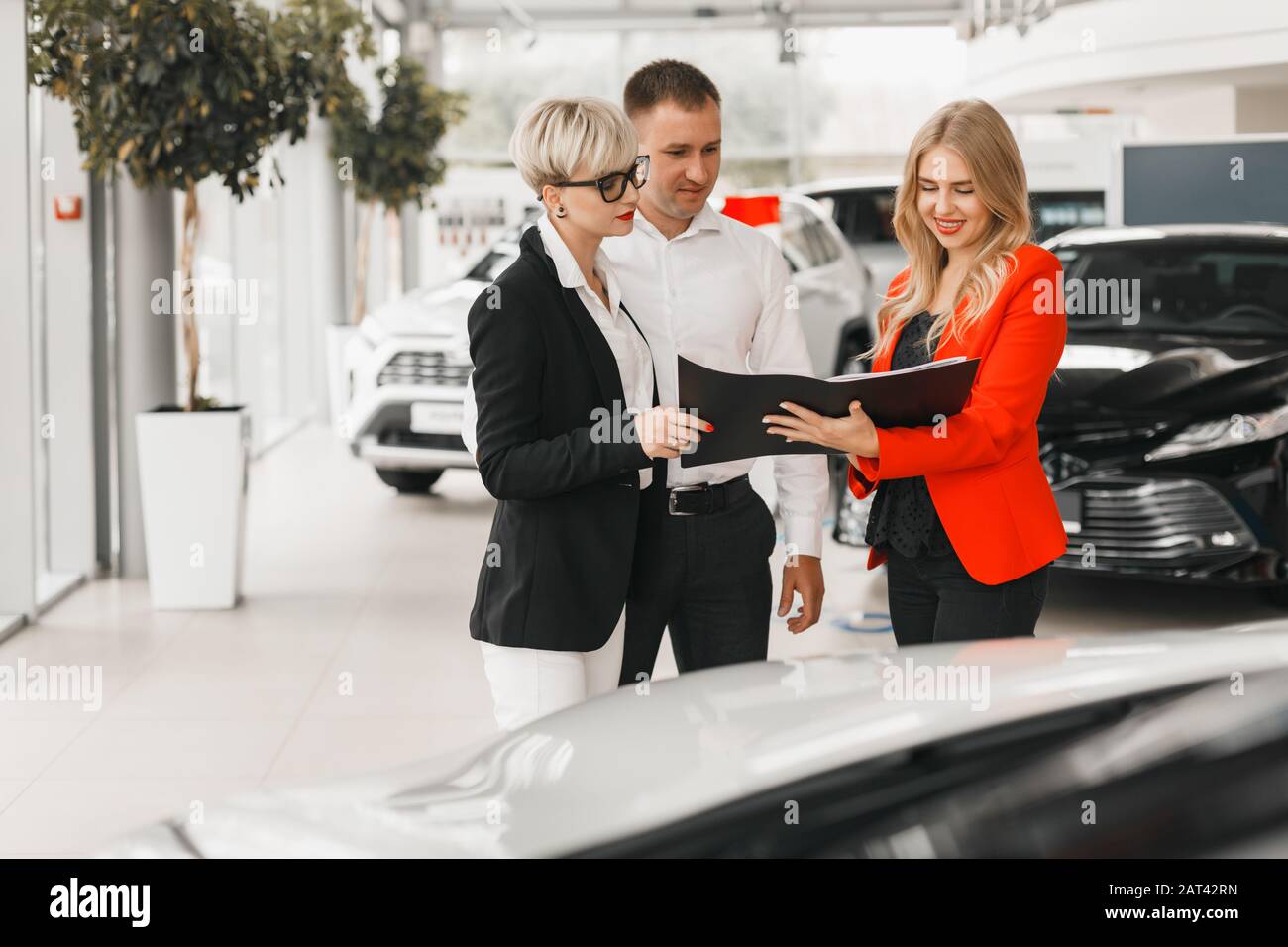Couple meeting with  dealer for choose and  buying the car  - Image Stock Photo