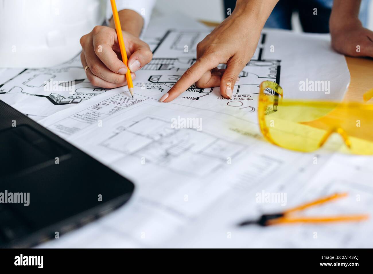 Hands of architects working on blueprints in the office Stock Photo - Alamy