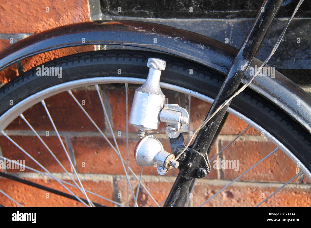 A Vintage Electric Generating Bicycle Dynamo Light Unit. Stock Photo