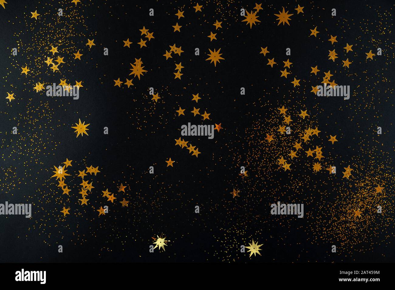 Golden stars on black background. Flat lay, top view Stock Photo - Alamy