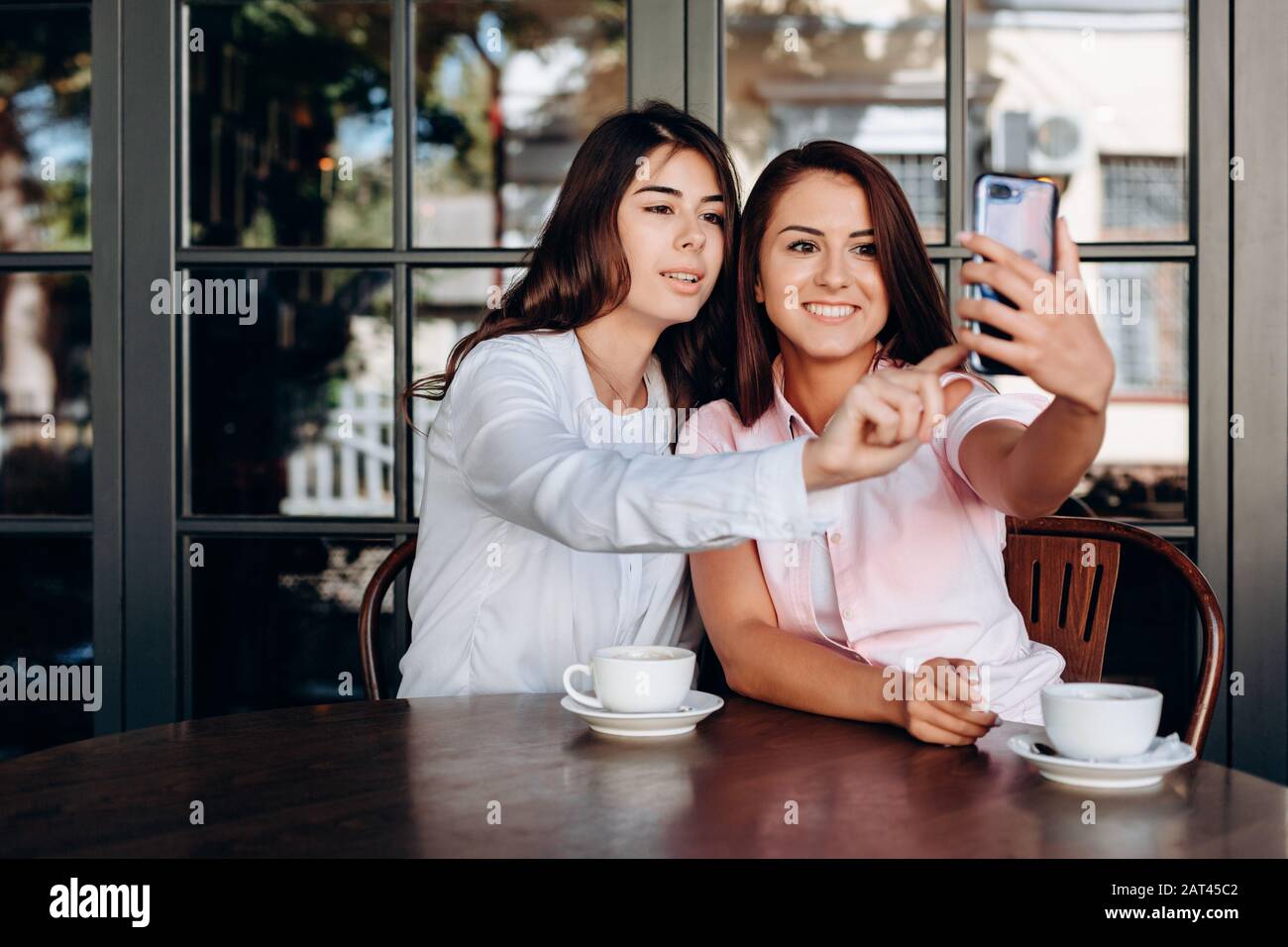 Girl taking selfie in cafe Stock Photo - Alamy