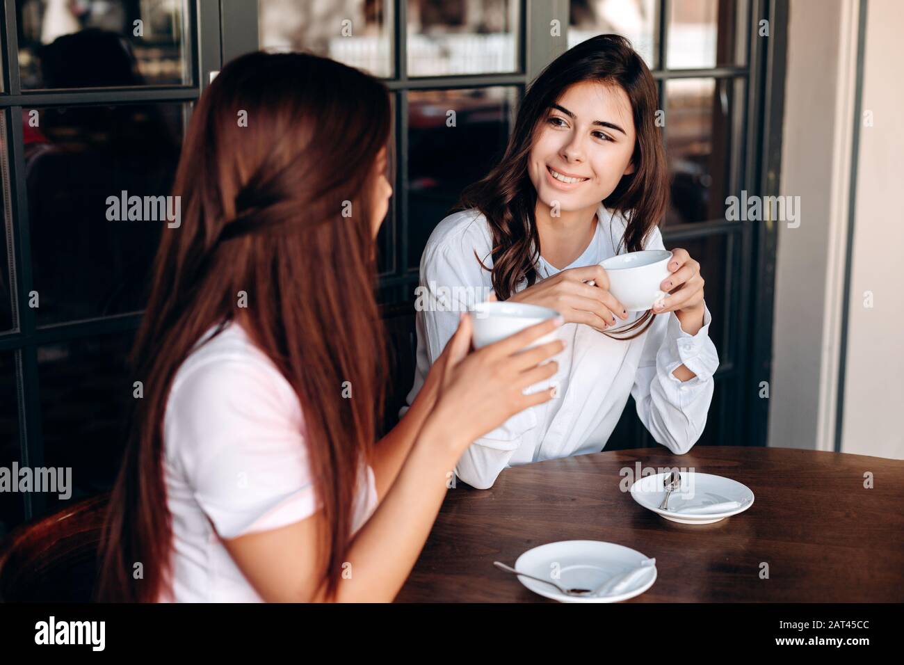 Beautiful girls drinking coffee during a business lunch in a cafe Stock ...