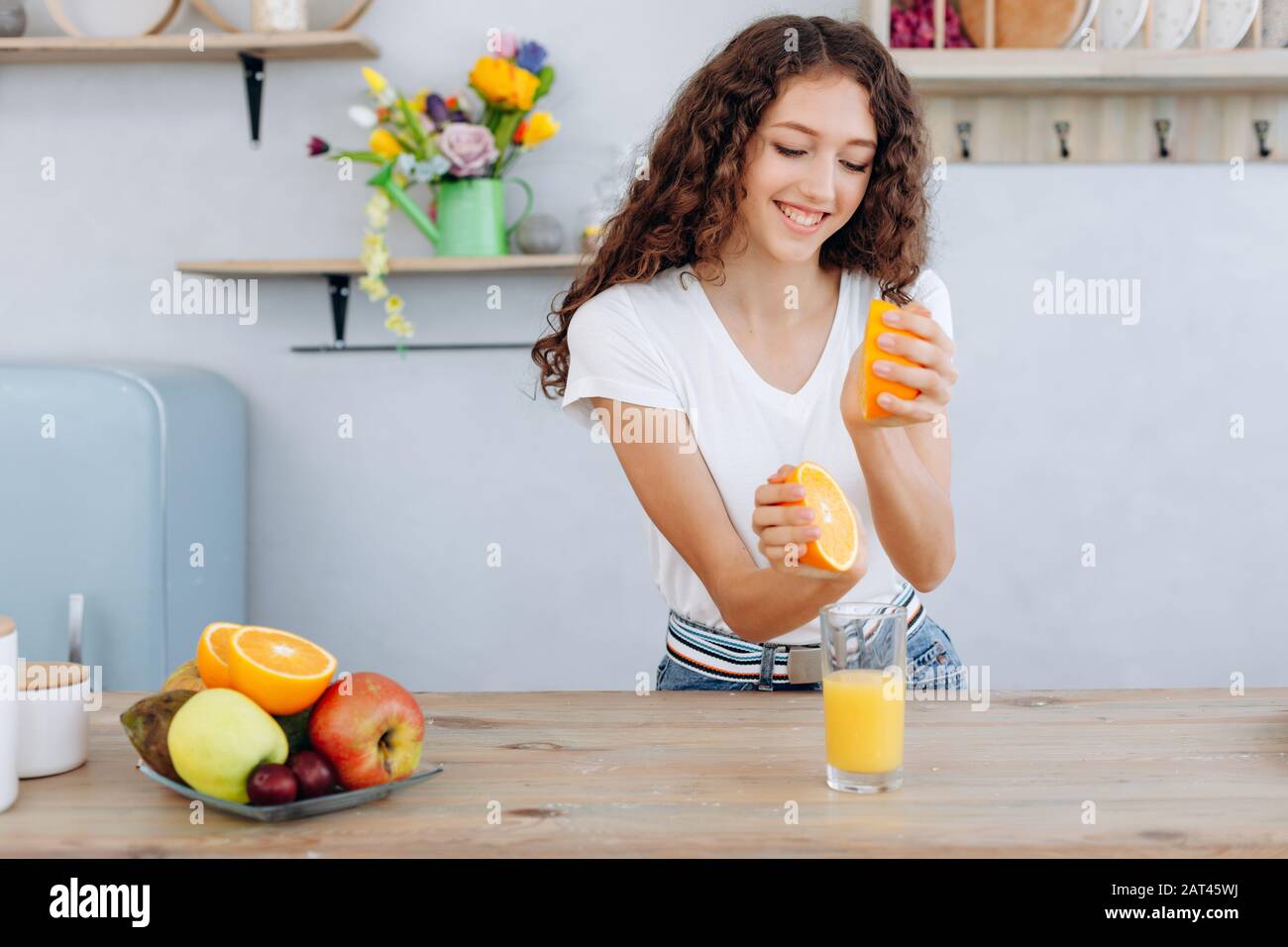 Girl make an orange juice by hand at home Stock Photo Alamy
