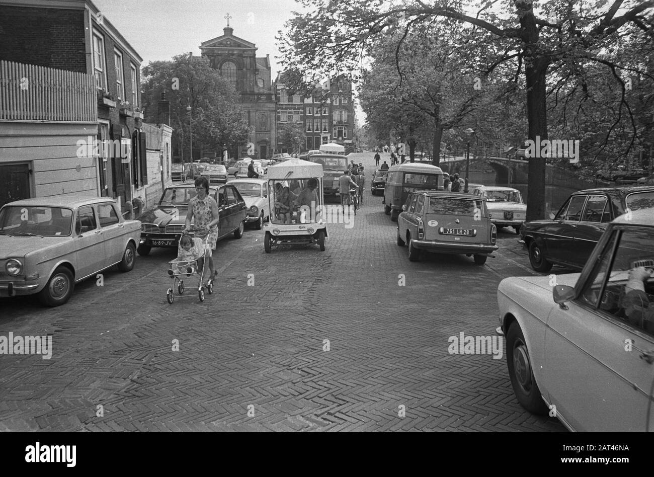 The first witkar (electric powered tricycle, available for subscribers) in Amsterdam  Industrial designer and politician Luud Schimmelpennink with his witkar Date: 23 May 1972 Location: Amsterdam, Noord -Holland Keywords: industrial design, politicians, inventions, means of transport Stock Photo