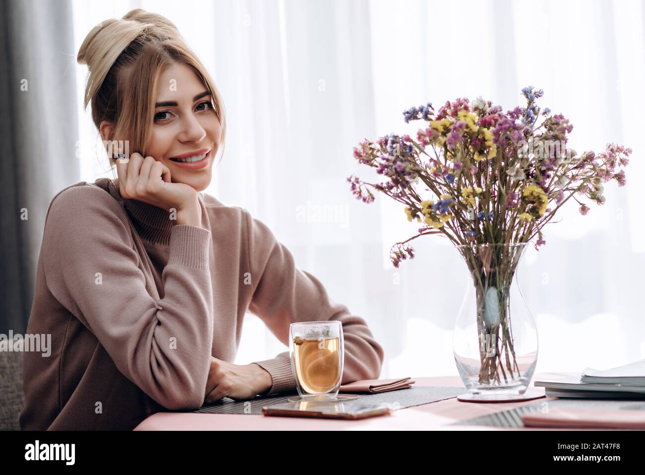 Smiling pretty girl sits in hi-res stock photography and images - Alamy