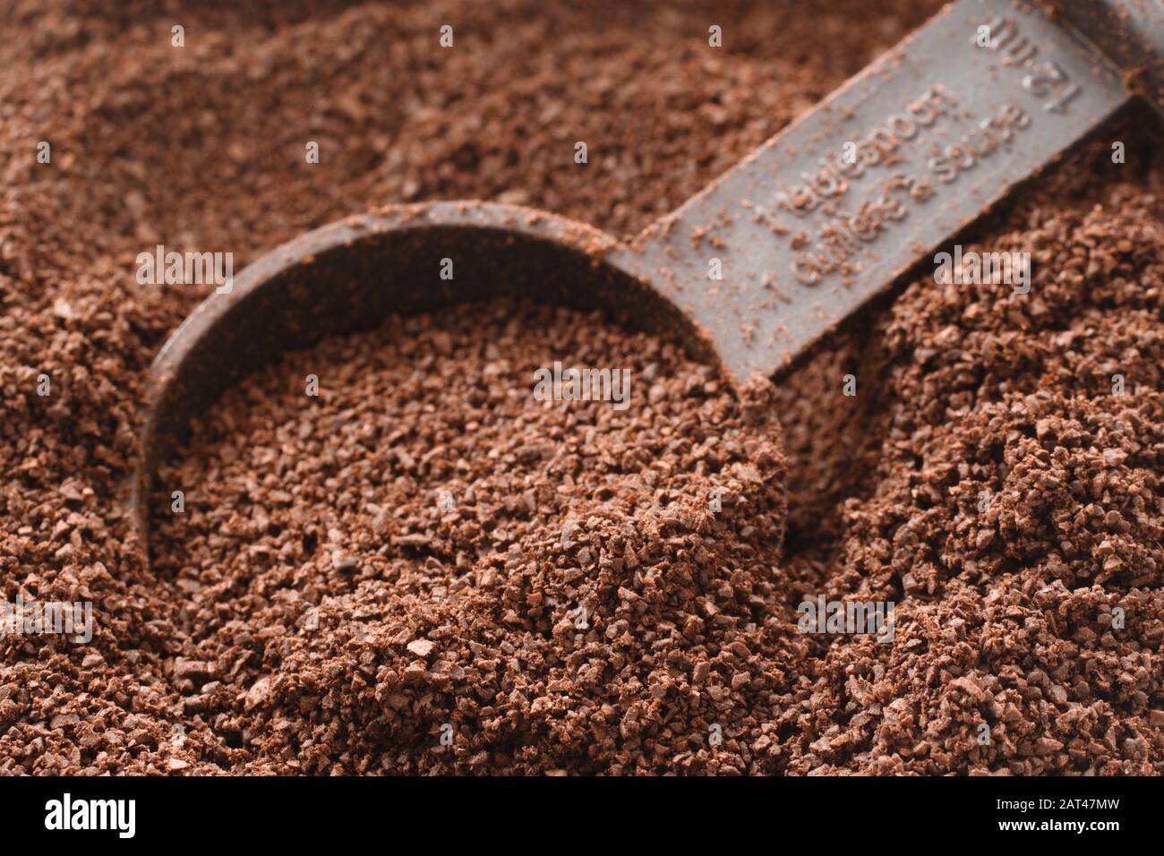 Rich coffee grinds and and measuring spoon Stock Photo