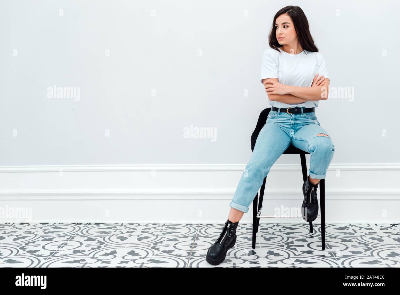 Girl sitting knees up smiling hi-res stock photography and images - Alamy