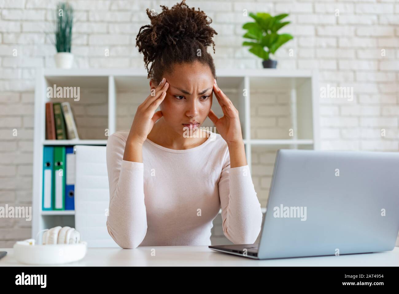 Woman portrait hands on temples hi-res stock photography and images - Alamy