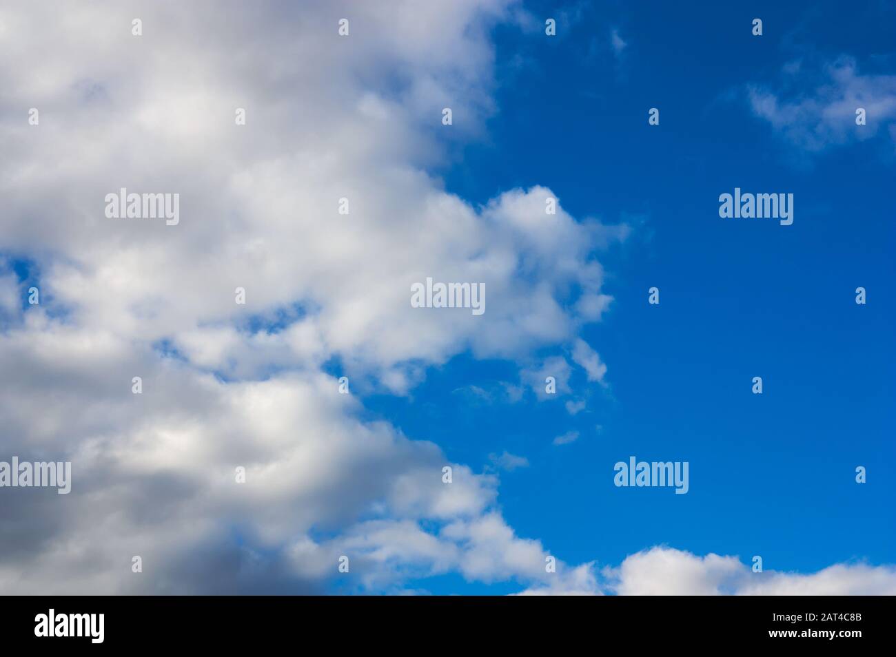 In the image as the gray storm clouds give way to the blue sky leaving room for texts and for conceptual backgrounds. (copy space) Stock Photo