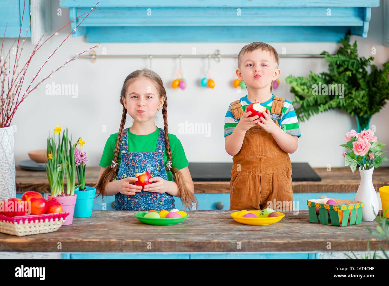 Happy easter. Cute brother and sister, funny kids boy and girl are preparing for the holiday. Stock Photo