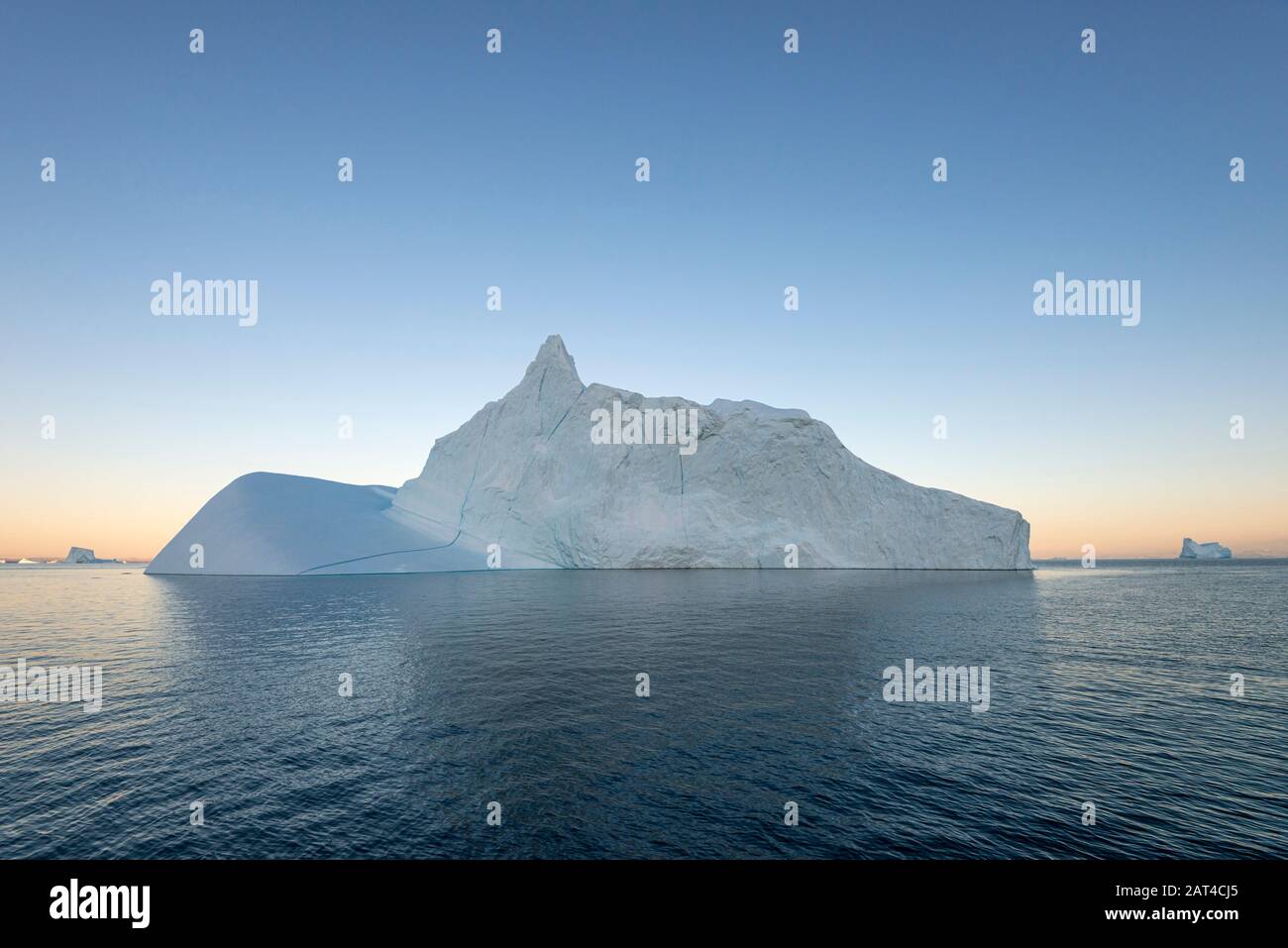 Icebergs at sunset in Hall Bredning, part of the Scoresby Sound fjord system, east Greenland Stock Photo