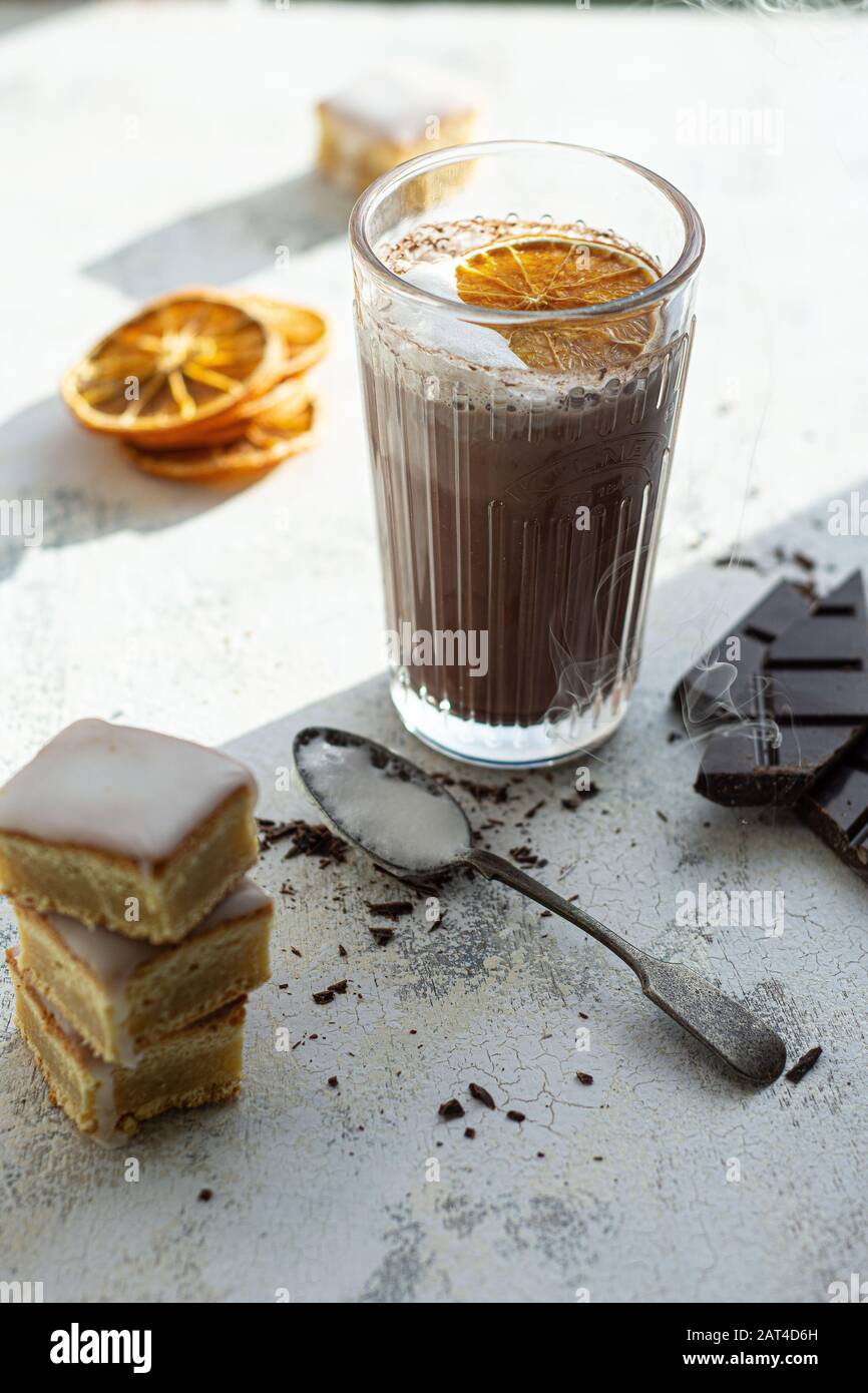 Hot chocolate in a glass with orange.Cookie lemon.Sweet drink and food Stock Photo