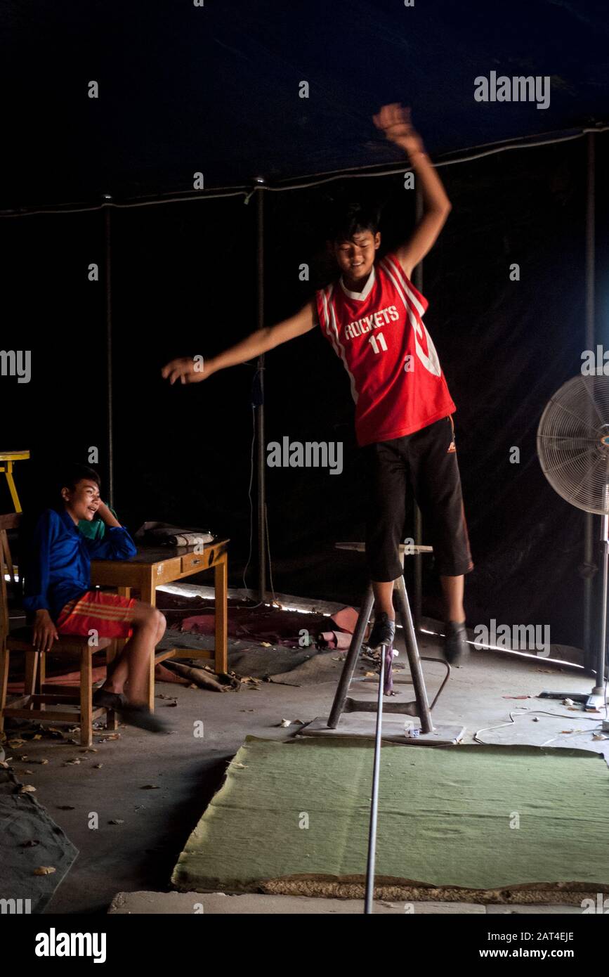 Battambang, Cambodia, Asia: a young acrobat of Phare Ponleu Selpak Circus is training to walk in balance on a tightrope Stock Photo