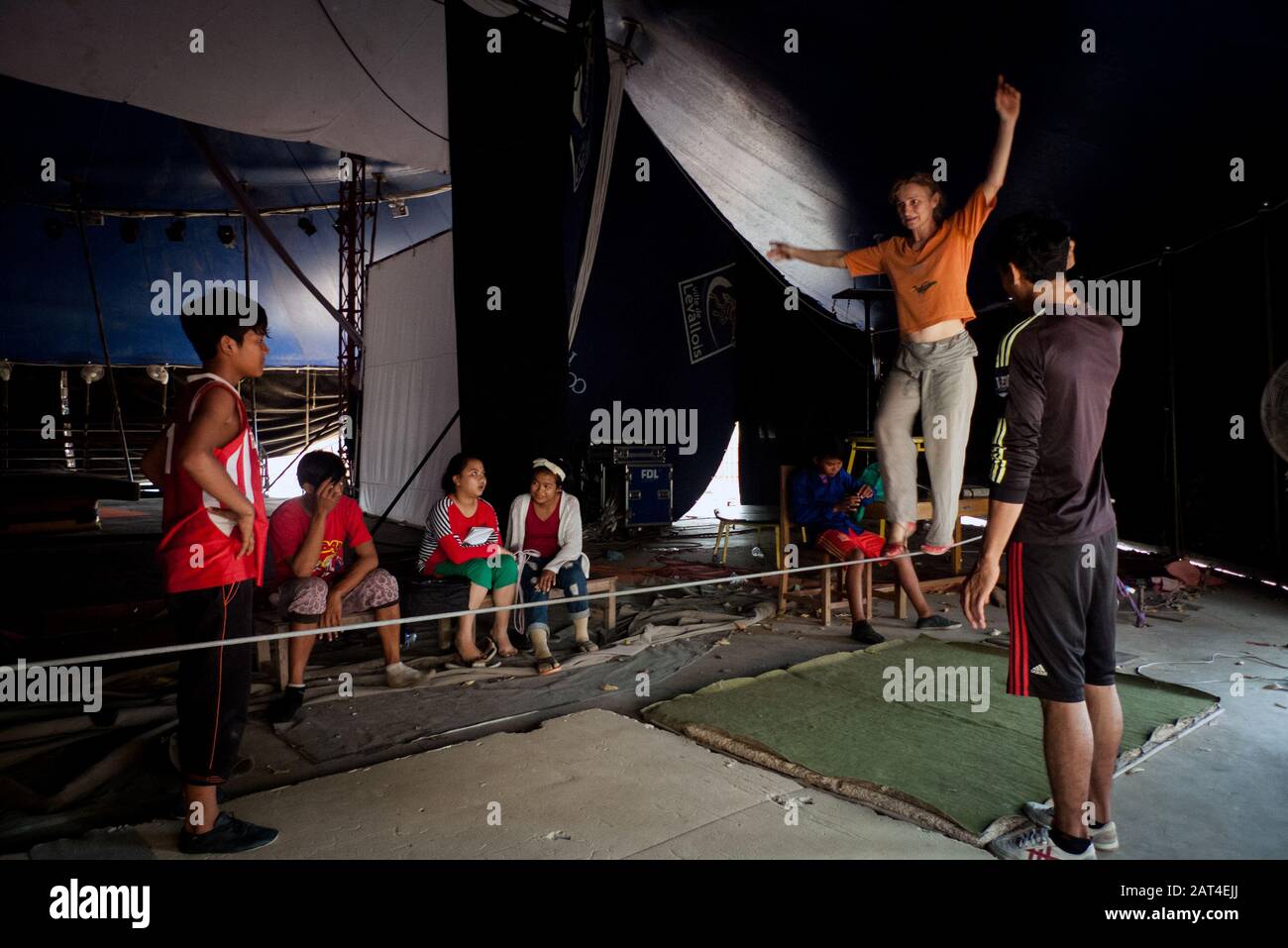 Battambang, Cambodia, Asia: an acrobat teacher from the Phare Ponleu Selpak Circus shows his students how to walk balanced on a tightrope Stock Photo