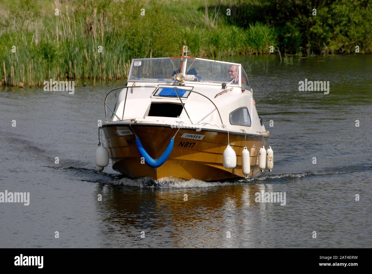 Small motor cruiser on river Thames Stock Photo