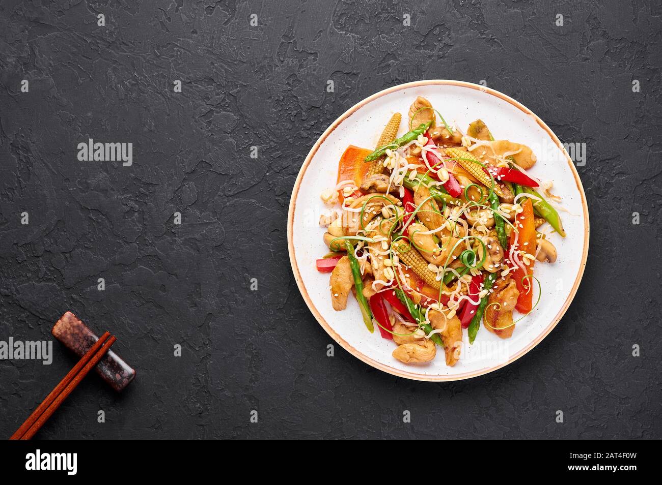 Chicken Chop Suey in white plate at black slate background. Chop Suey